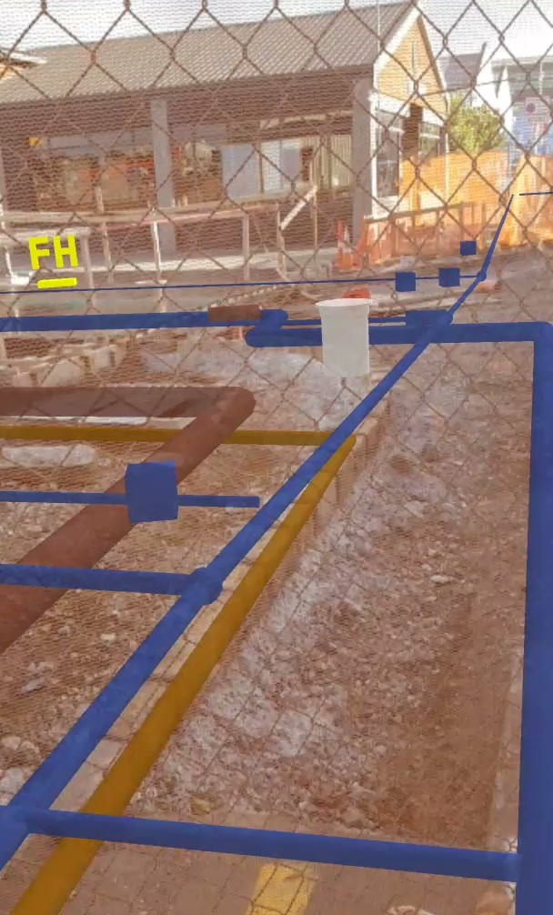 Mapped and modelled service lines over a construction site viewed through a fence in Augview.